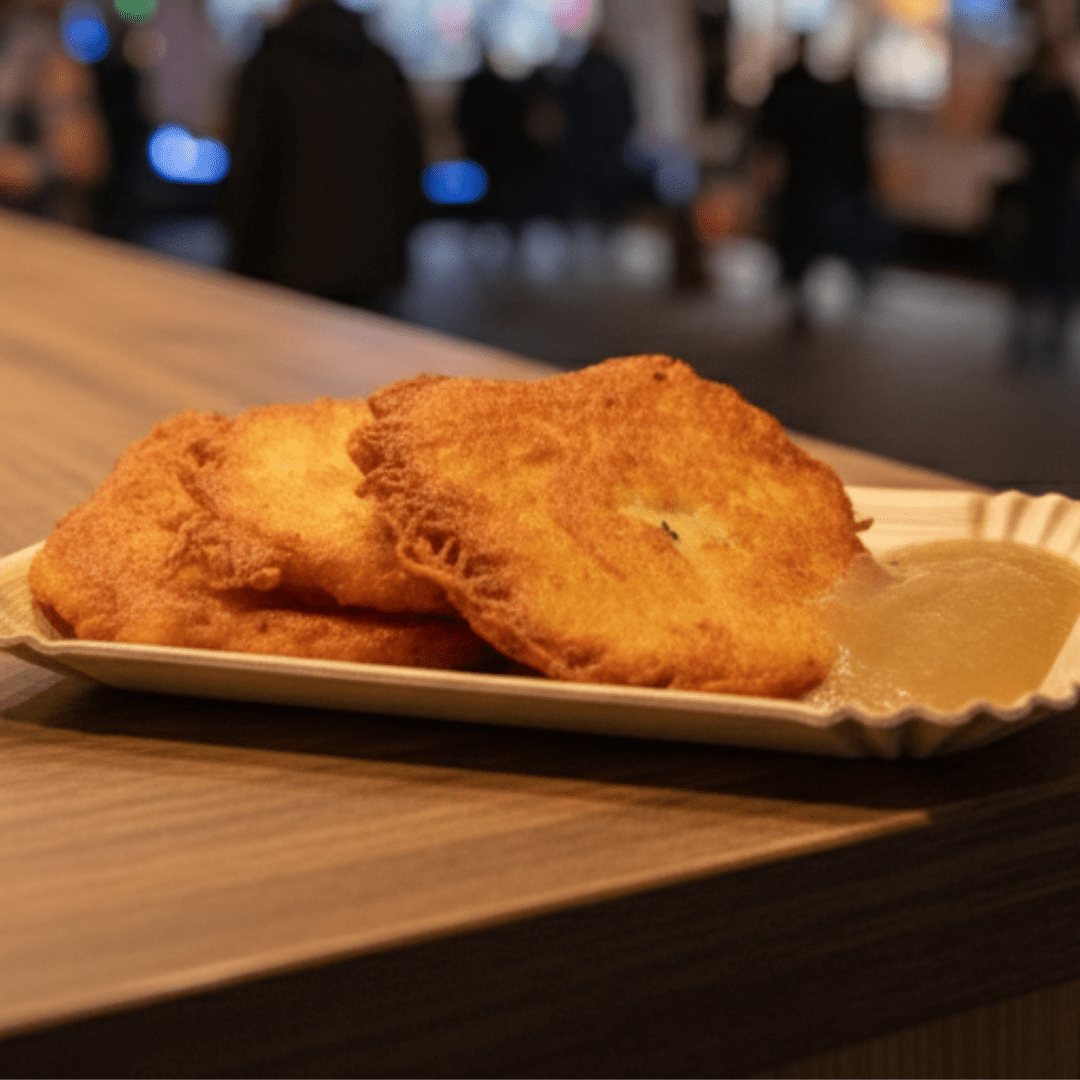 Drei Reibekuchen mit Apfelmus auf einem Teller